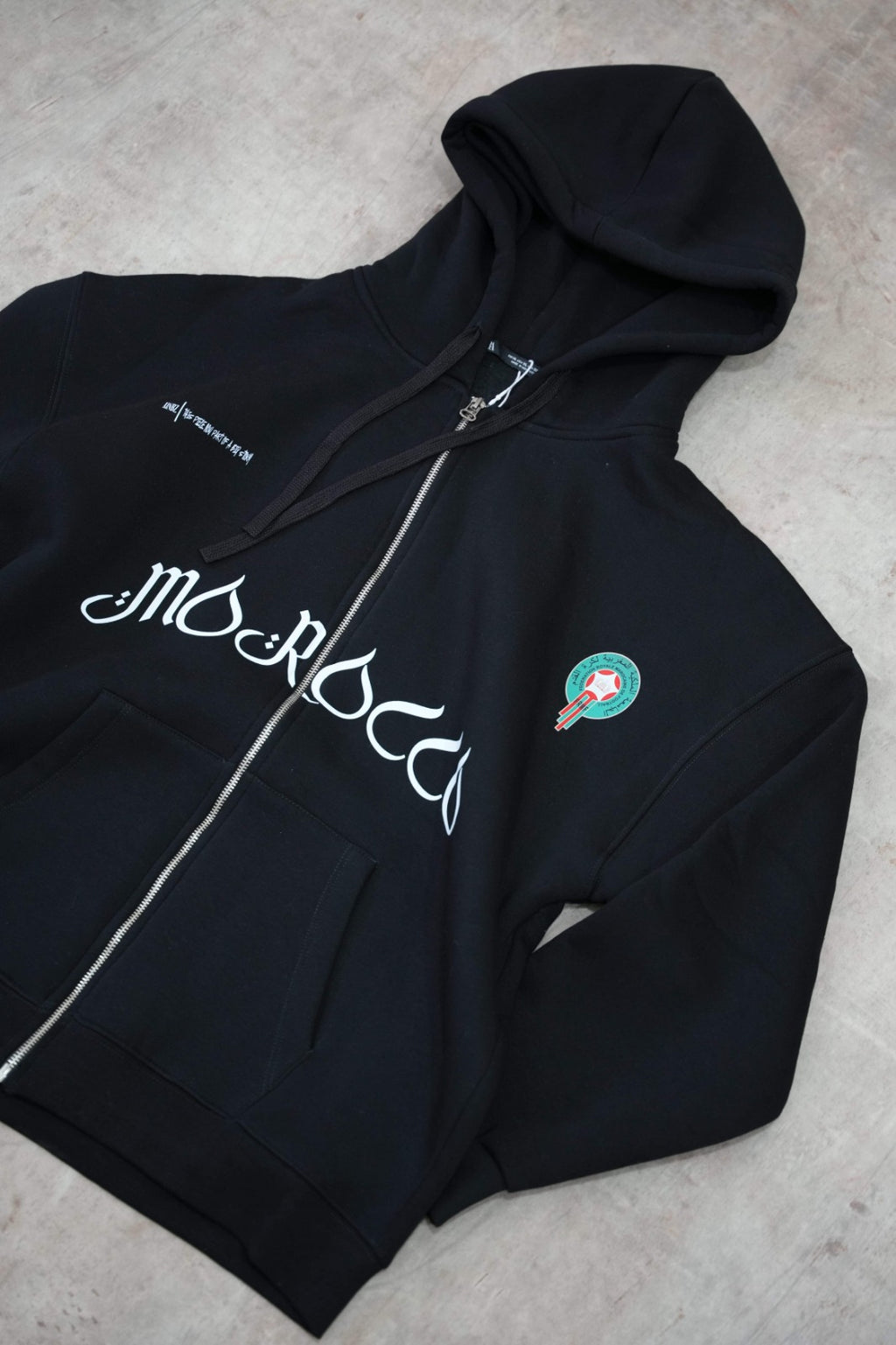 Black zip-up hoodie with a clean, premium streetwear aesthetic.