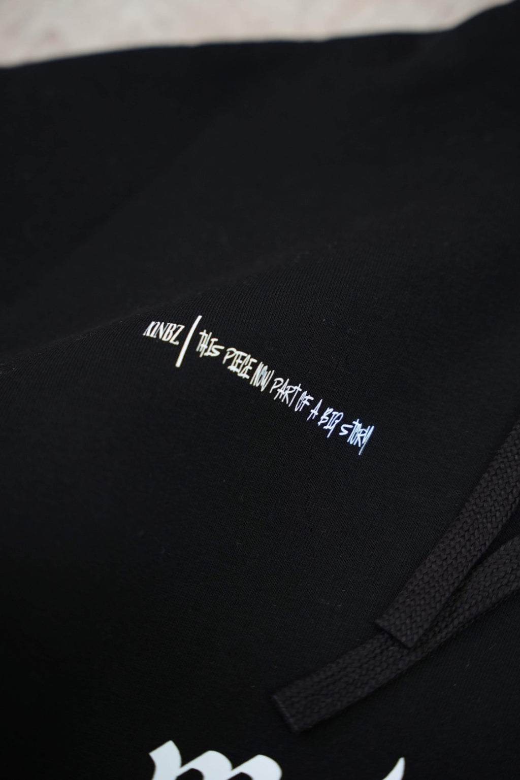 Black zip-up hoodie with a clean, premium streetwear aesthetic.