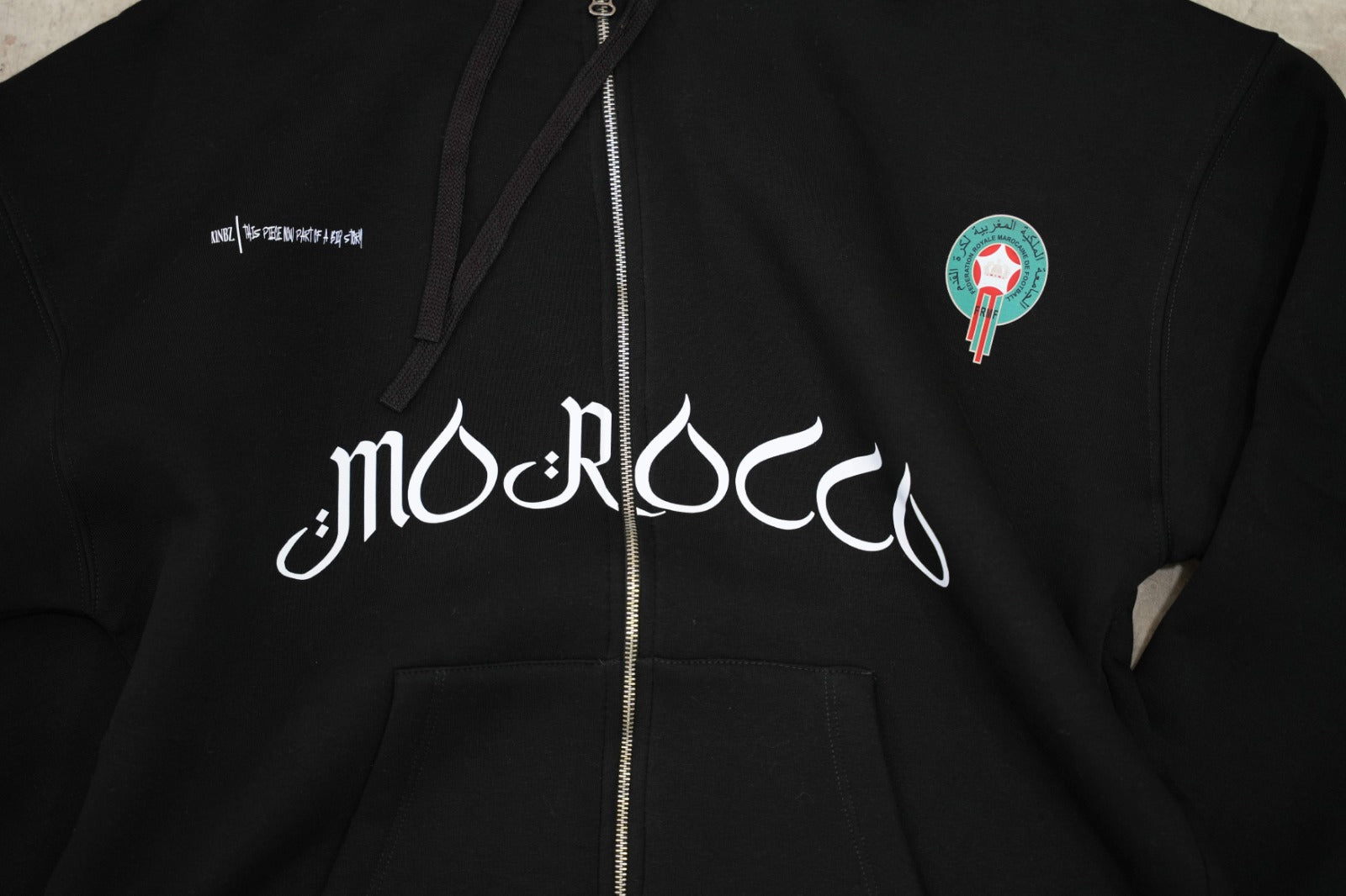 Black zip-up hoodie with a clean, premium streetwear aesthetic.